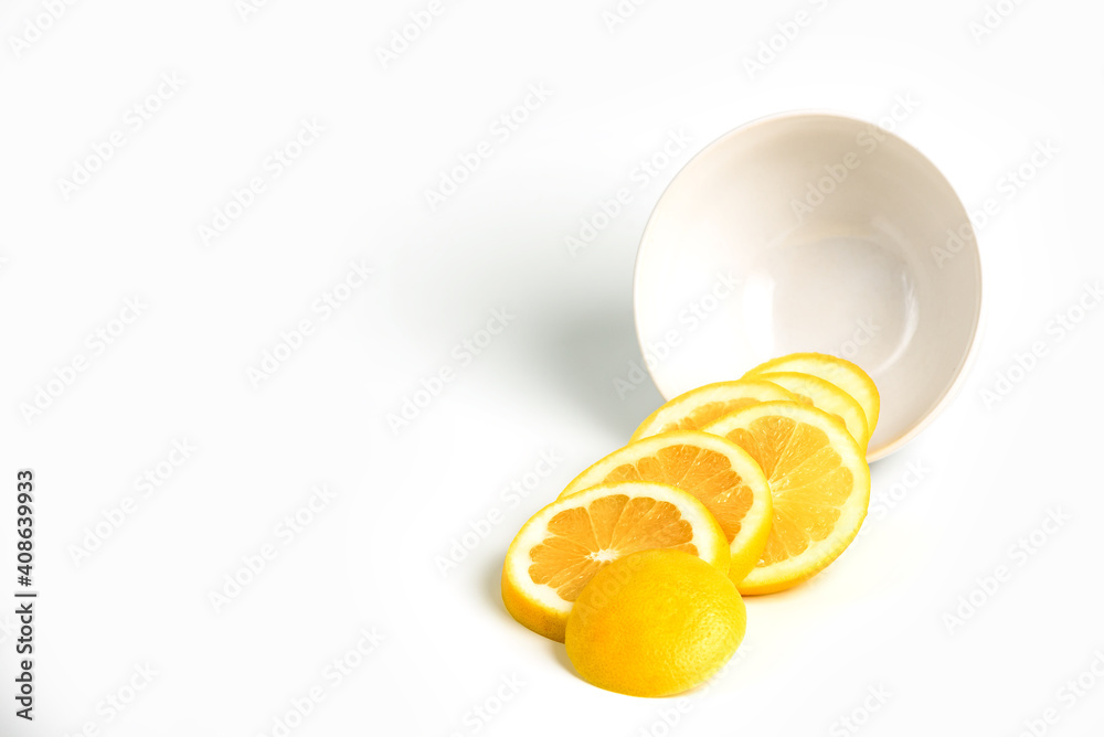 Isolated grapefruits slices out of a bowl. Grapefruit - circular slices of fresh grapefruit isolated on white background with copy space