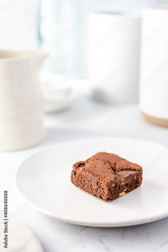 Chocolate cake on a plate with a white colour palette Chocolate cake on a plate with a white colour palette