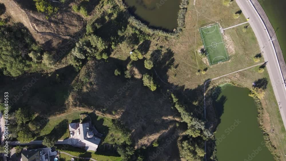 Aerial view of a heart-shaped lake in the middle of a field and forest in summer daylight Aerial view of a heart-shaped lake in the middle of a field and forest in summer daylight