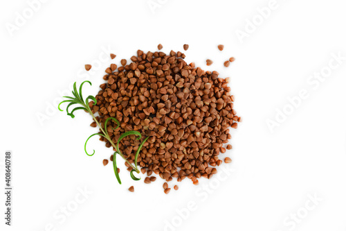 Buckwheat and a sprig of greenery on a white background.Healthy food.