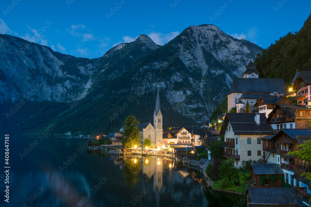 Evangelical Parish Church by Hallstatter See against mountains at twilight, Hallstatt, Austria Evangelical Parish Church by Hallstatter See against mountains at twilight, Hallstatt, Austria