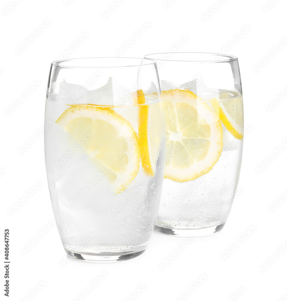 Soda water with lemon slices and ice cubes on white background Soda water with lemon slices and ice cubes on white background