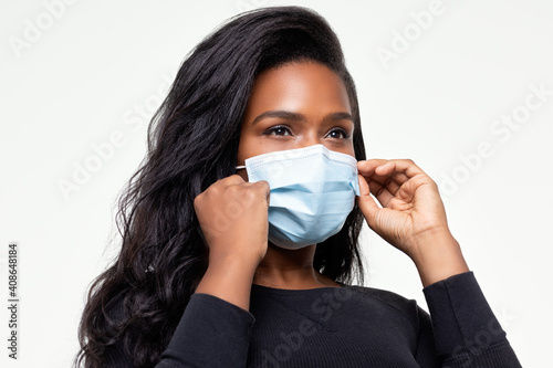 African-American woman adjust her mask for a proper fit 0335 photo