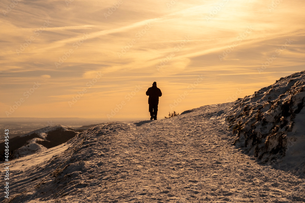 Walker on the Malvern Hills in snowy weather Worcestershire UK