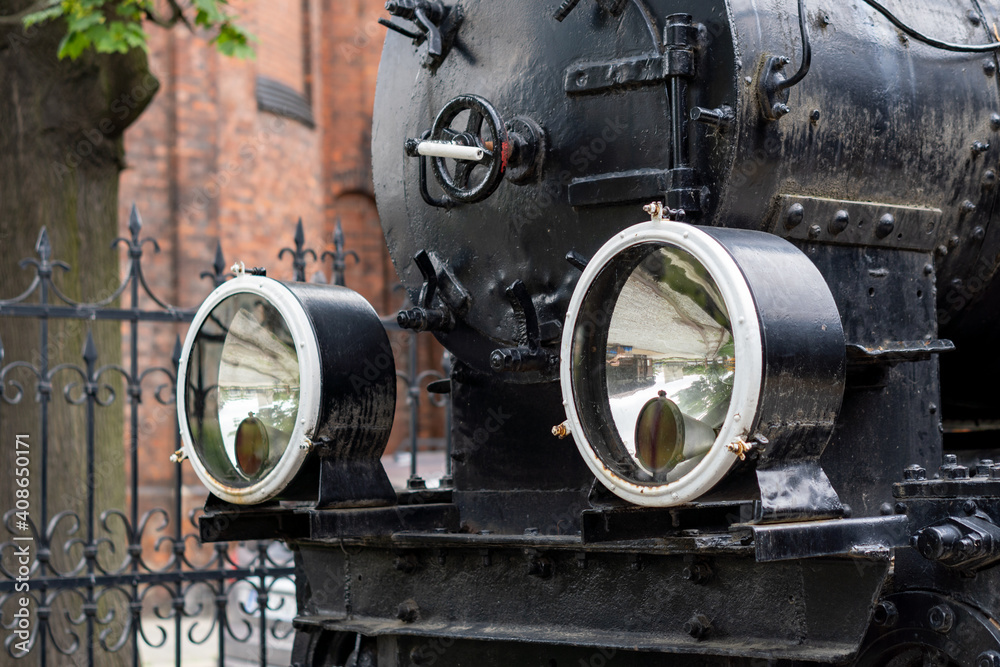 The front of an old steam train.