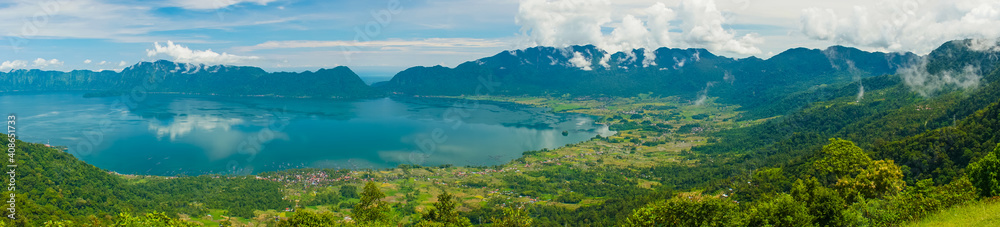 Super wide panoramic view of Maninjau Lake at West Sumatra, Indonesia. Beautiful nature Indonesia landscape with mountains background.