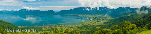 Super wide panoramic view of Maninjau Lake at West Sumatra  Indonesia. Beautiful nature Indonesia landscape with mountains background.