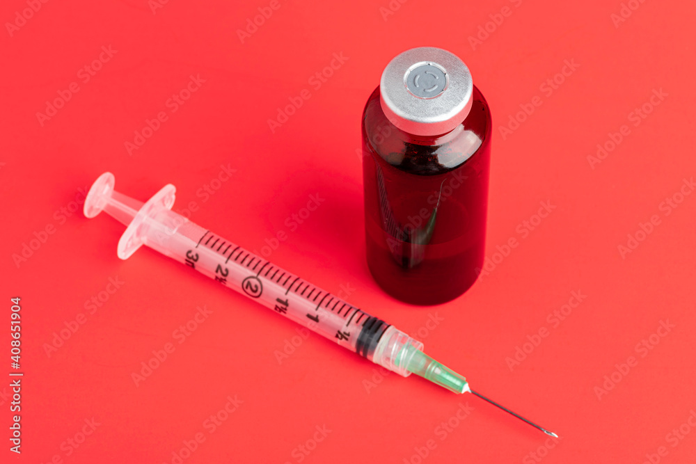 Disposable Syringe Injection And Amber Color Vial On Red Background Disposable Syringe Injection And Amber Color Vial On Red Background