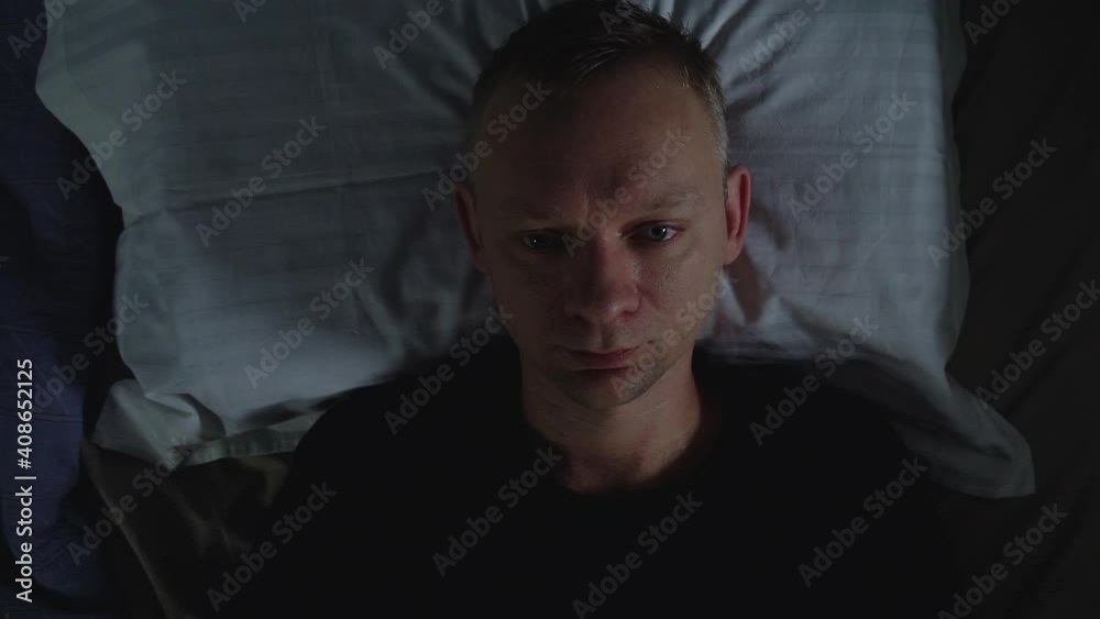 Tired Man fall to pillow and goes to sleep in bedroom and enjoying healthy good sleep at night