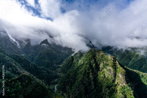 Green cloud-covered mountain peaks on Madeira Island
