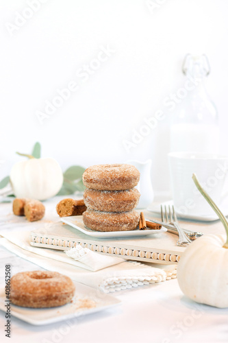 stack of apple cider donuts on white background