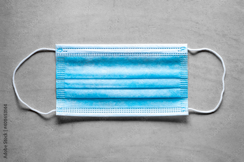 Covid-19 medical surgical face mask. Coronavirus mouth protection on grey background Covid-19 medical surgical face mask. Coronavirus mouth protection on grey background
