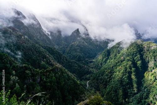Green cloud-covered mountain peaks on Madeira Island photo