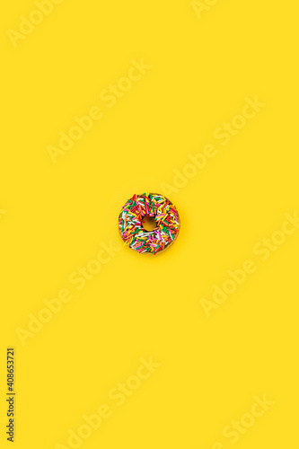 rainbow sprinkle donut isolated on yellow