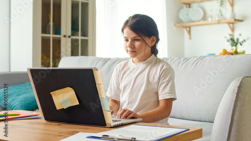 Schoolgirl Chatting on Webcam While Preparing for a Test or Exam with an Online Teacher.