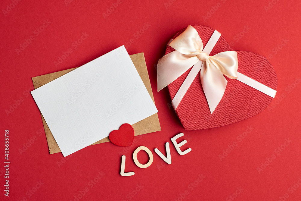 Valentines day card mockup with envelope and gift box with heart on red paper background Valentines day card mockup with envelope and gift box with heart on red paper background