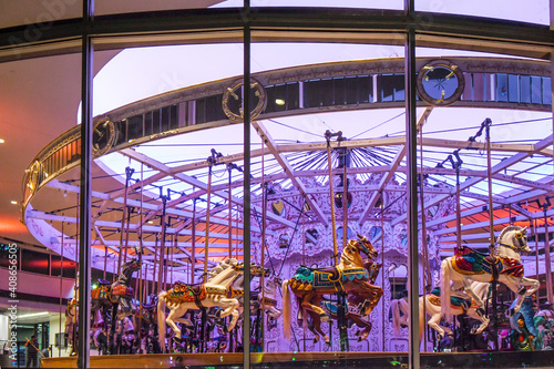 The colorful interior of a carousel with it's lilac lights and vintage horses in Riverfront Park, Spokane, Washington.