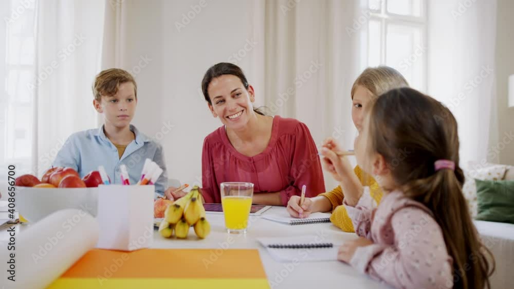 Group of homeschooling children with teacher studying indoors, coronavirus concept. Group of homeschooling children with teacher studying indoors, coronavirus concept.