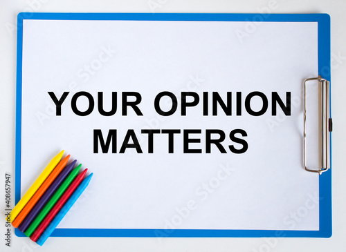 Colored pencils and clipboard with a text Your Opinion Matters