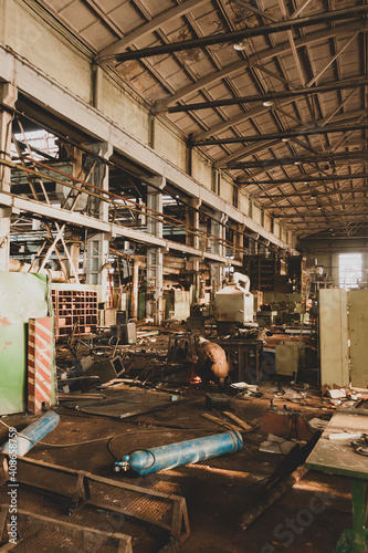 The abandoned old large industrial hall is waiting for demolition, disassembly of the plant for scrap, The former Khabarovsk plant for the production of a diesel engine.