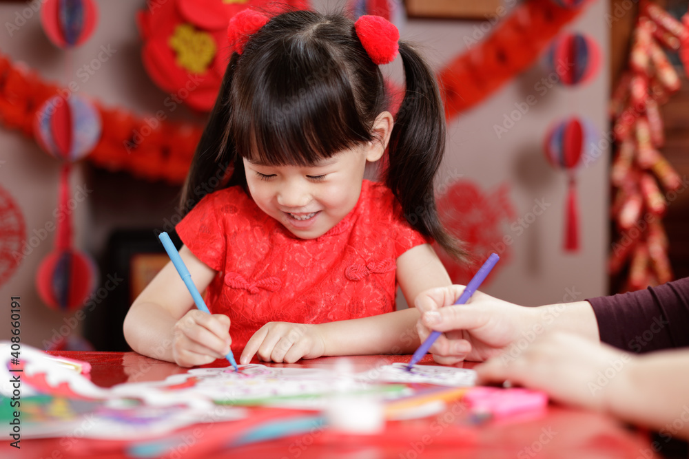 young chinese girl making paper craft for celebrating chinese new year ...