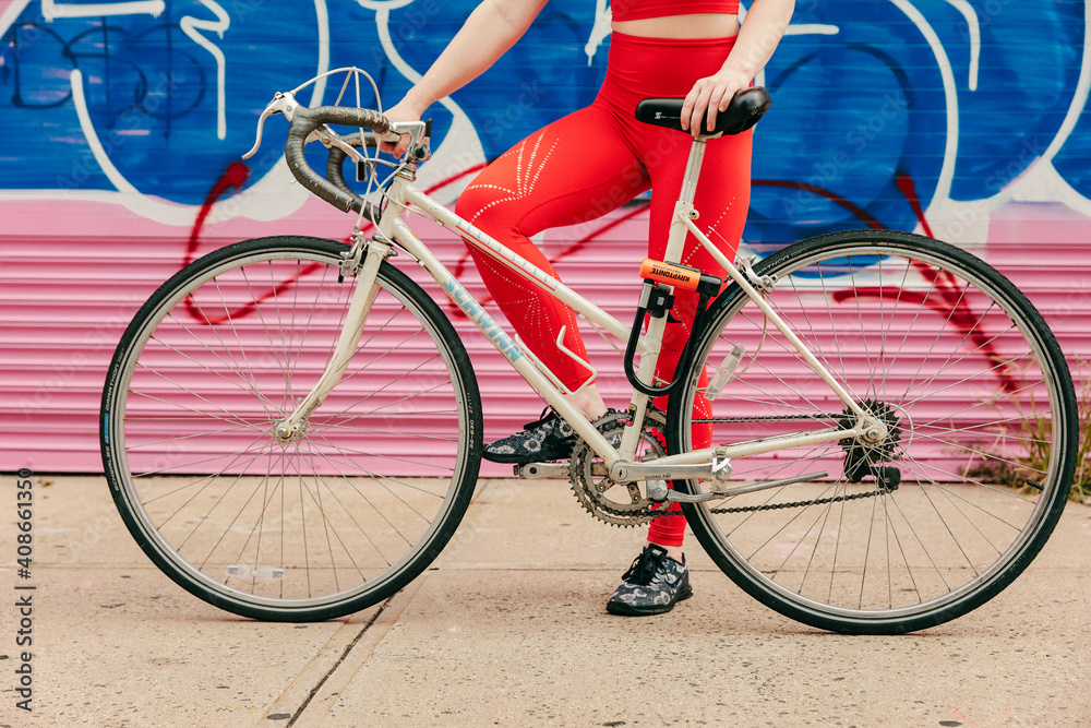 Young female athlete with bicycle outdoors in Brooklyn street. Young female athlete with bicycle outdoors in Brooklyn street.