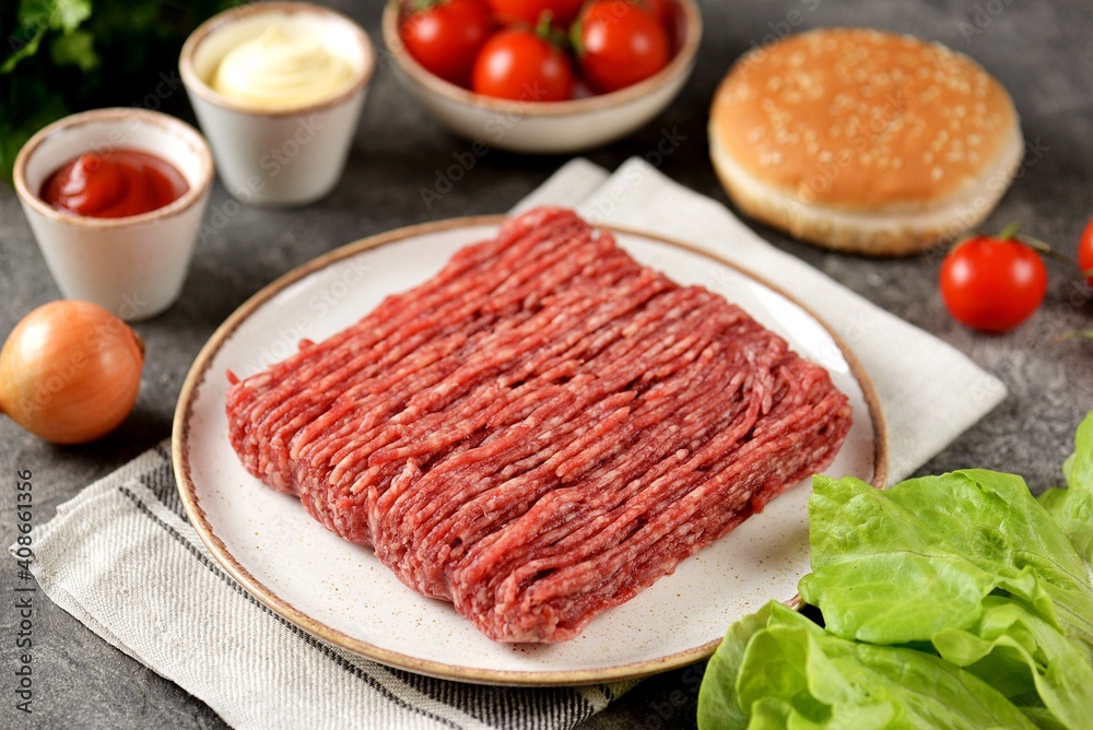 Fresh beef mince and ingredients ready to cook cheeseburgers. Fresh beef mince and ingredients ready to cook cheeseburgers.