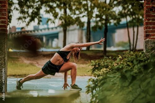 Young woman exercising outdoors in park. photo