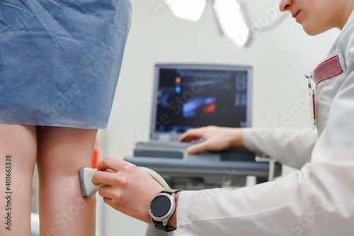 Doctor ultrasound knee test. Scan medical equipment. Diagnosis ultrasound foot. photo