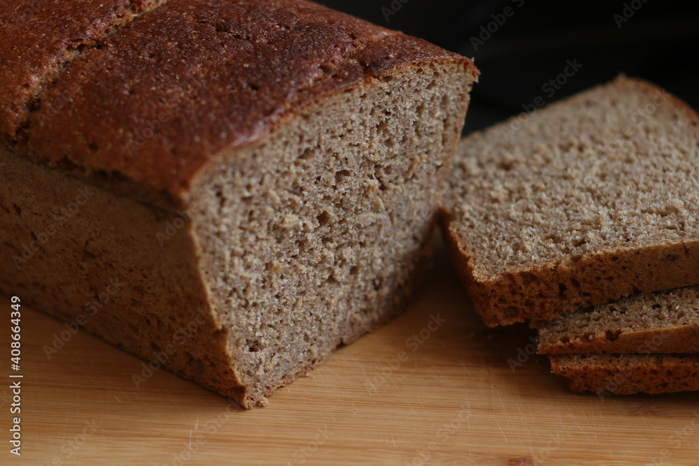 Healthy dark bread on a wooden background. Bio ingredients, homemade, for breakfast.
