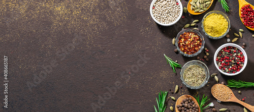 Fototapeta Naklejka Na Ścianę i Meble -  Long wide banner with assortment of spices and herbs on brown stone background. Template food blog social media. Spices market banner concept.