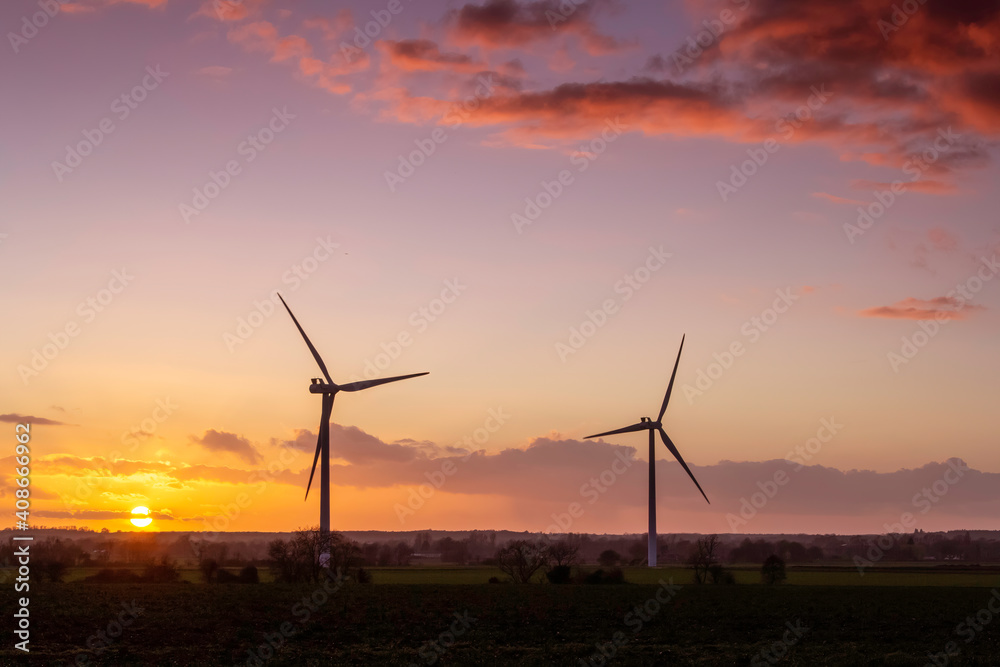 wind turbines at sunset bright red clouds landscape view. wind turbines at sunset bright red clouds landscape view.