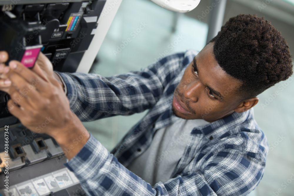 technician is checking and changing the printer equipment cartridges technician is checking and changing the printer equipment cartridges