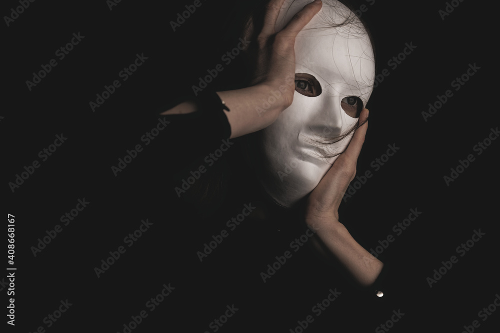 portrait of a woman in a white mask in the dark. portrait of a woman in a white mask in the dark.