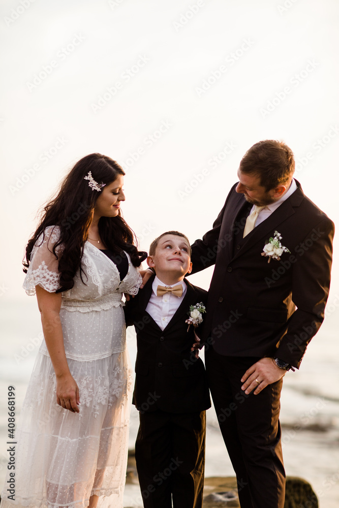Newlyweds & Nine Year Old Son Standing on Rock at Beach in San Diego Newlyweds & Nine Year Old Son Standing on Rock at Beach in San Diego