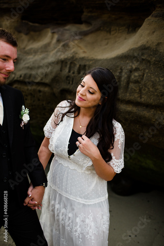 Newlywed Mom Smiling at Son While Standing on Beach in San Diego photo