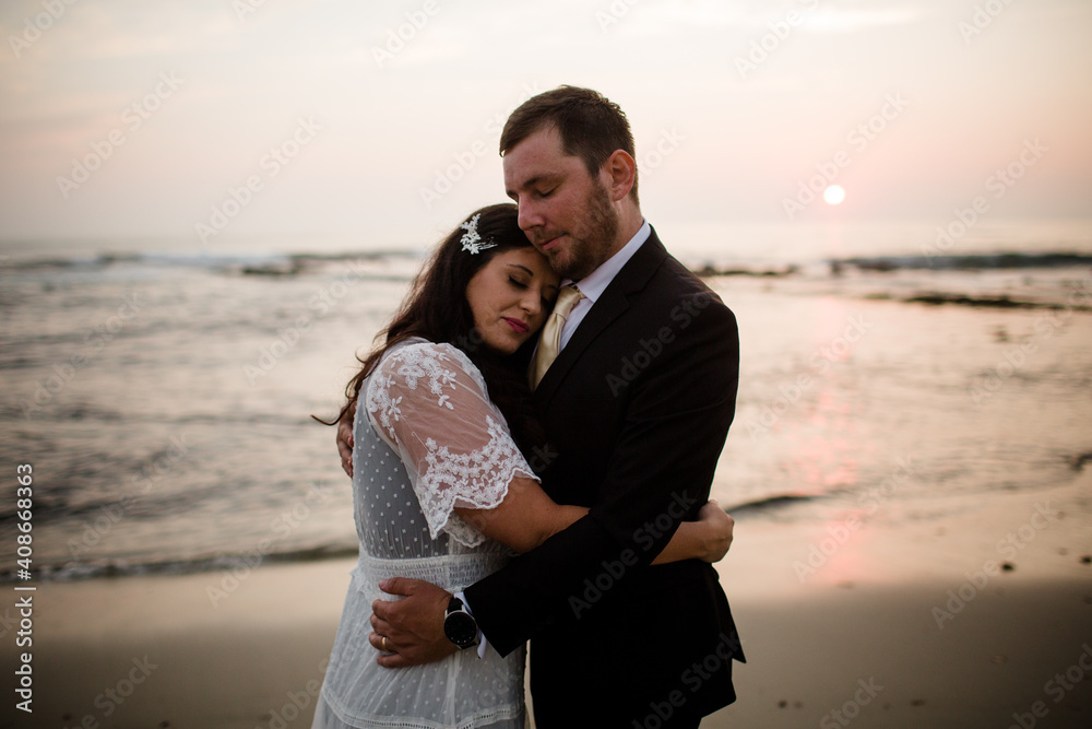 Newlyweds Posing on Beach at Sunset in San Diego Newlyweds Posing on Beach at Sunset in San Diego