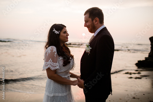 Newlyweds Posing on Beach at Sunset in San Diego photo