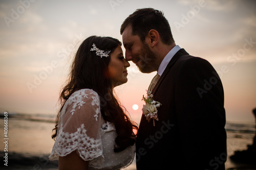 Newlyweds Posing on Beach at Sunset in San Diego photo