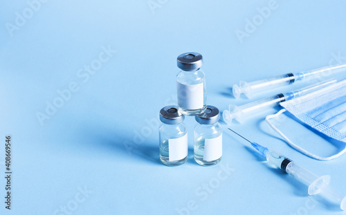 Vaccination against the new Corona Virus SARS-CoV-2: A Syringes and glass vials with liquid. Health and vaccination concept. Medical injection. Needle, dosage scale. Top view, flat lay with copy space