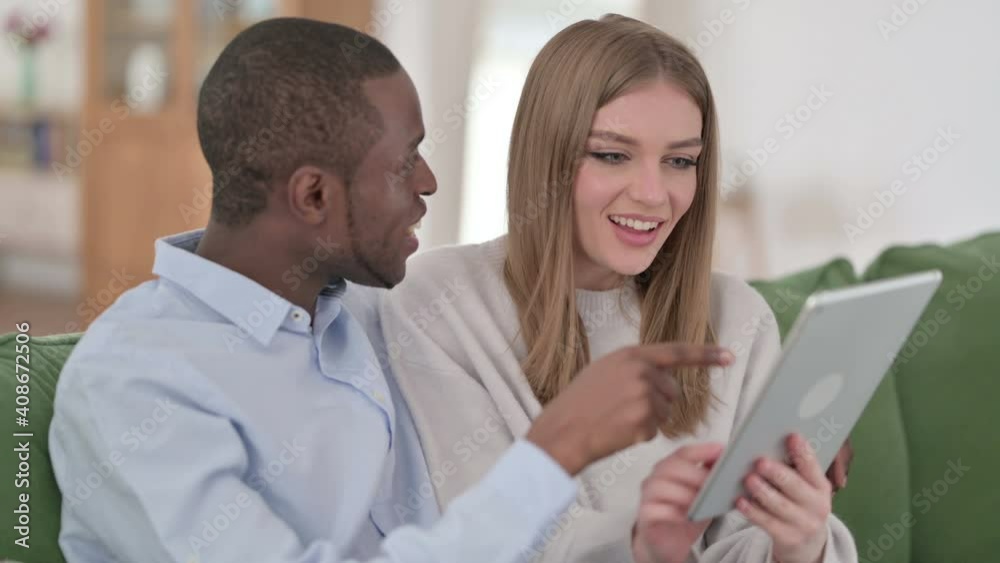 Loving Mixed Race Couple using Tablet Together at Home Loving Mixed Race Couple using Tablet Together at Home