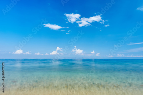 La Cara (Koutloumousiou) beach, Sithonia, Chalkidiki, Greece; view at calm sea with clouds and peninsula of Athos; beach serenity; peacefulness and calmness concept