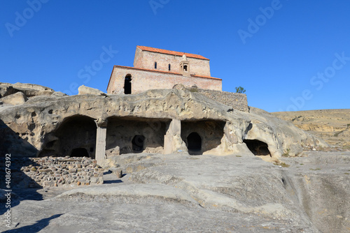 Cave town of Uplistsikhe with Uplistsulis Eklesia above. Ruins of city in the rock located in Georgia. Ancient site listed by UNESCO Heritage.