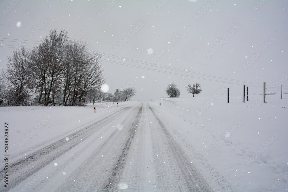 Snow-covered road in winter in the countryside
