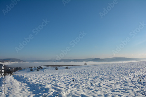 Snow landscape with fields and fog  and many blue sky © Claudia Evans 