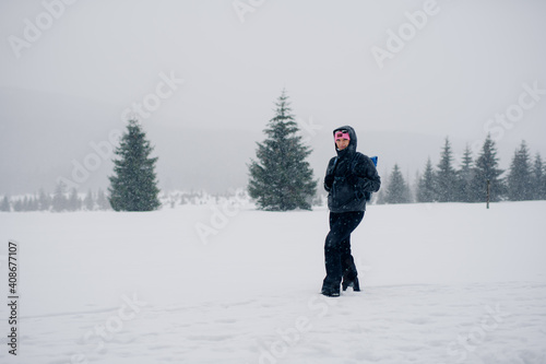 Hiker Walking in Mountains in Winter