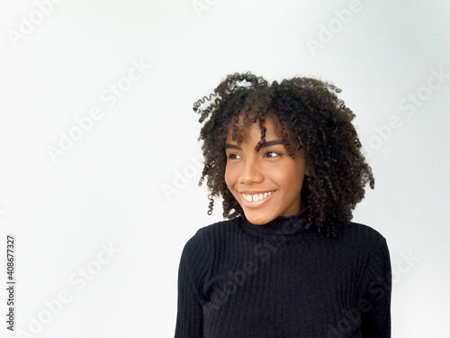 African American young woman smiling with black t-shirt on white background