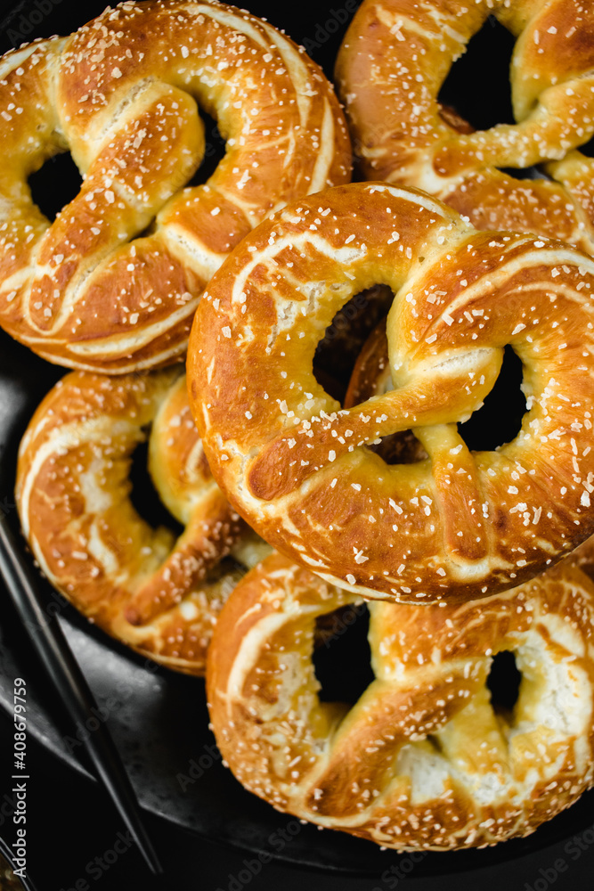 homemade pretzels with salt on black background homemade pretzels with salt on black background
