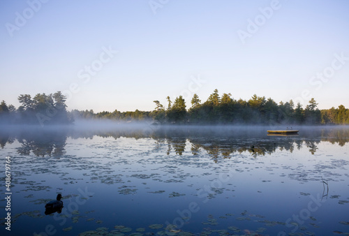 Calm lake water  with mist shot in Muskoka, Ontario Cottage Country photo