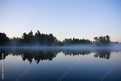 Calm lake water with mist shot in Muskoka, Ontario Cottage Country